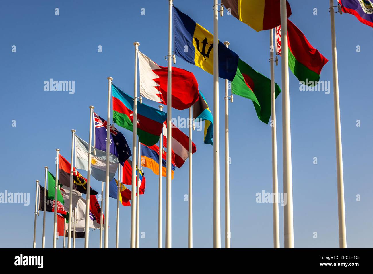 Many National Flags waving on the wind: Belarus, Bangladesh, Barbados, Bahrain, Bahamas, Azerbaijan, Austria, Australia, Armenia, Argentina, Angola. Stock Photo