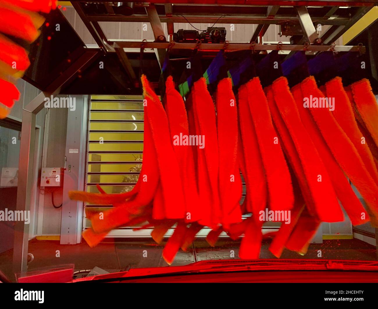 Inside automatic conveyorized tunnel car wash. View from inside car