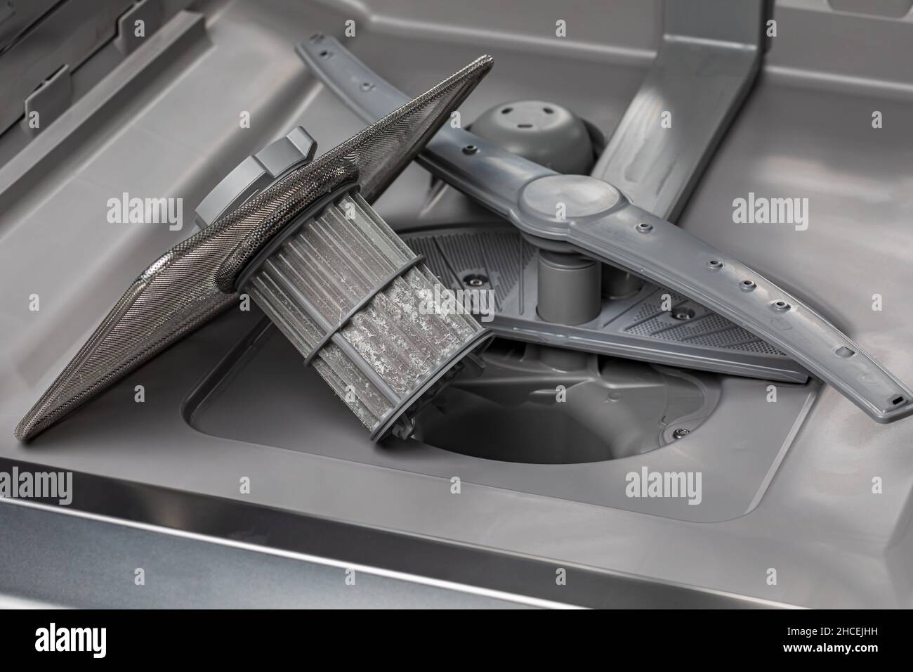 Dishwasher filter screen in bottom of dishwasher. Home appliance repair, maintenance and service concept. Stock Photo