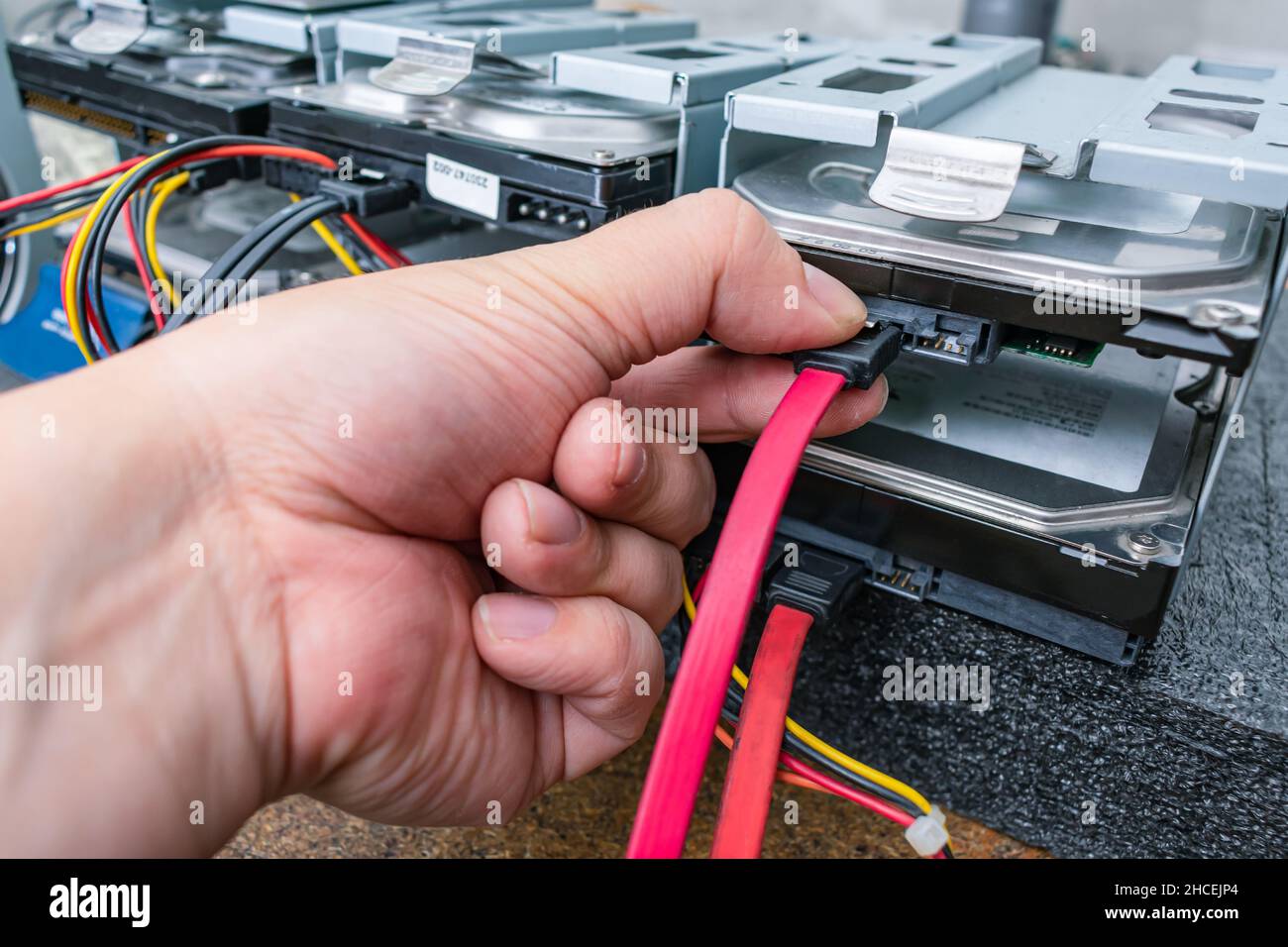 Service engineer maintains servers with data on hard drives Stock Photo