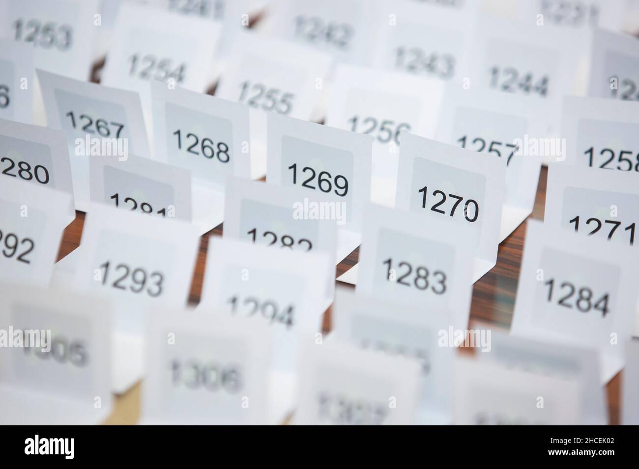 Different numbers printed on sheets of papers organized in a row Stock Photo