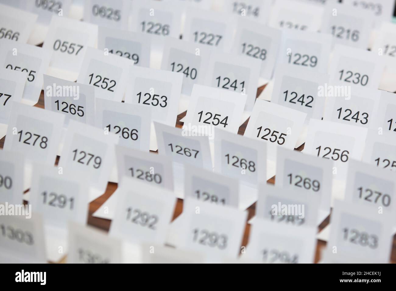 Different numbers printed on sheets of papers organized in a row Stock Photo