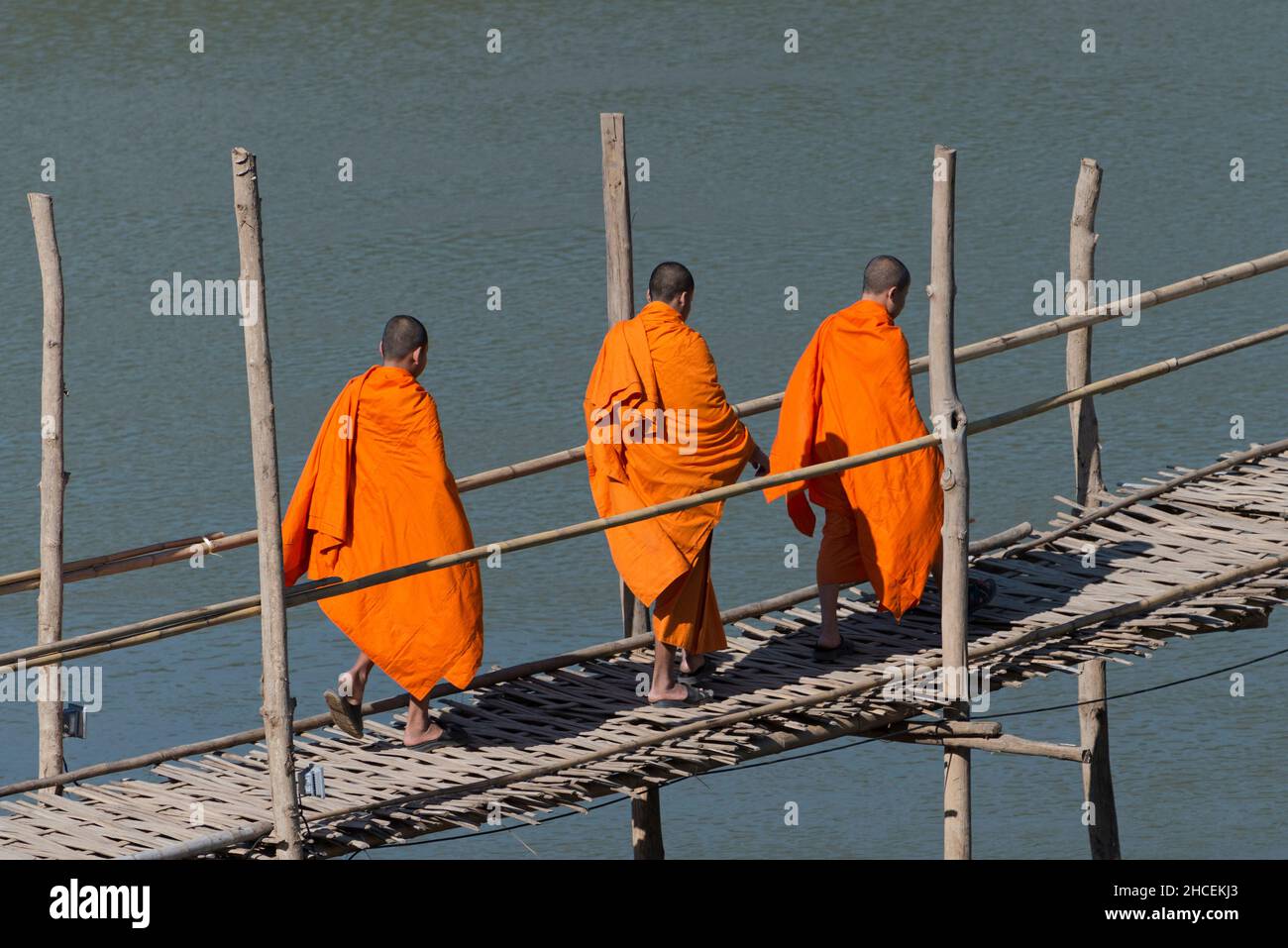 Buddhist Monks crossing the river Stock Photo