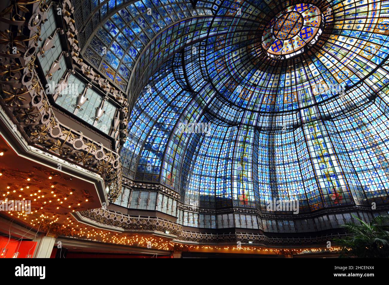 An ornate stained glass dome covers Brasserie Printemps, a restaurant at the flagship Printemps department store on Boulevard Haussmann in Paris. Stock Photo