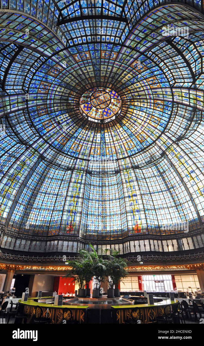 An ornate stained glass dome covers Brasserie Printemps, a restaurant at the flagship Printemps department store on Boulevard Haussmann in Paris. Stock Photo