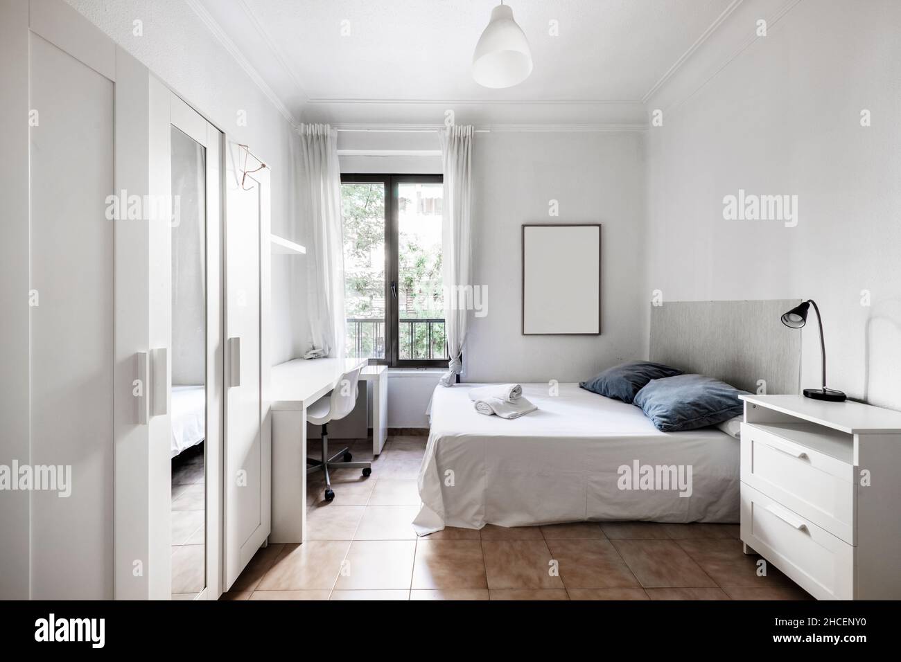 Room with large bed, study table and builtin wardrobe in rental room