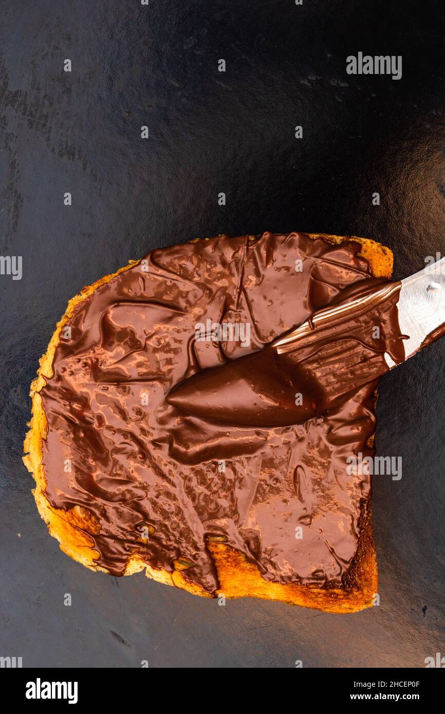 Spreading chocolate cream on toasted bread Stock Photo