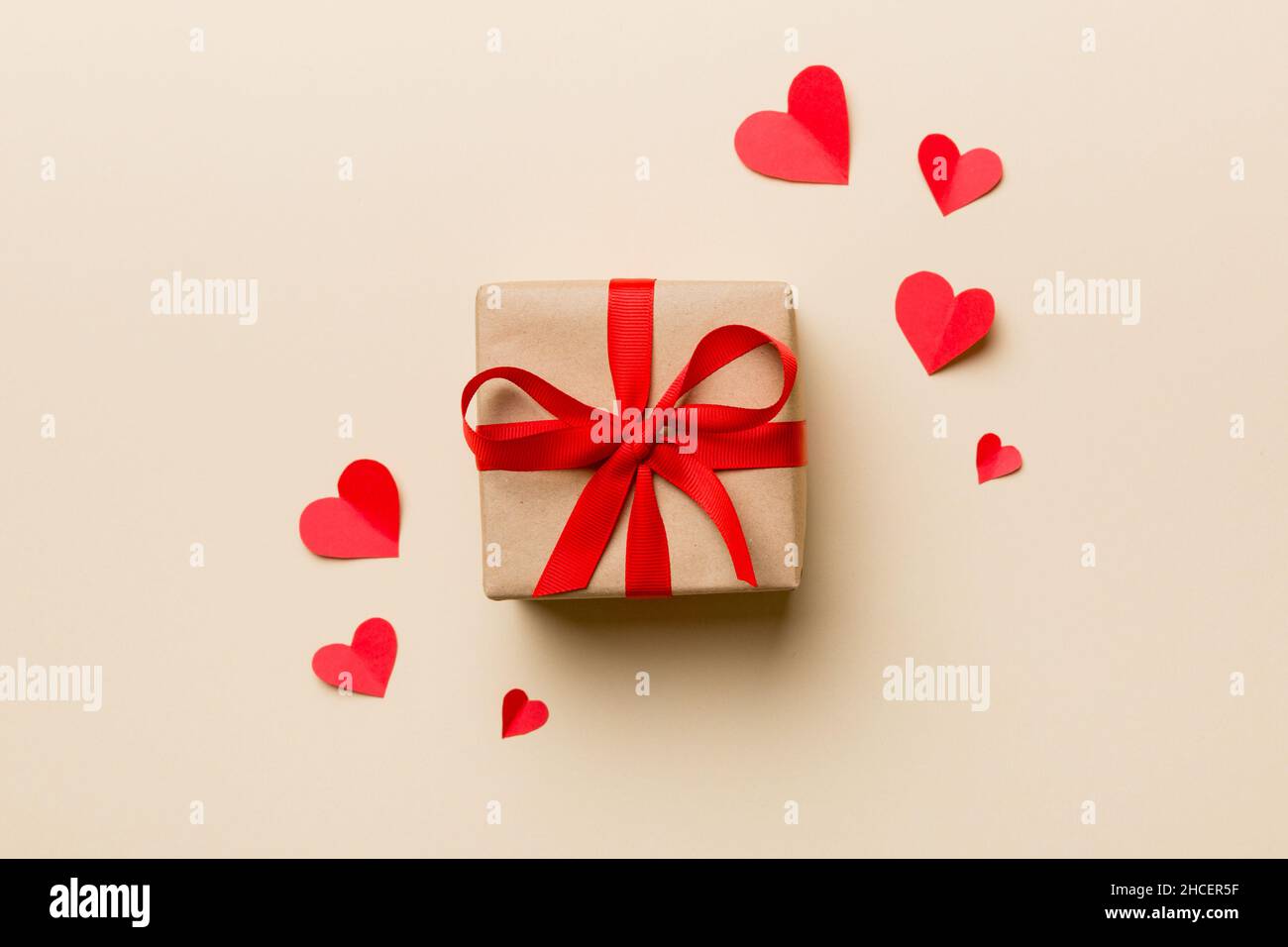 Valentine day composition Background: red gift box with bow and heart ...