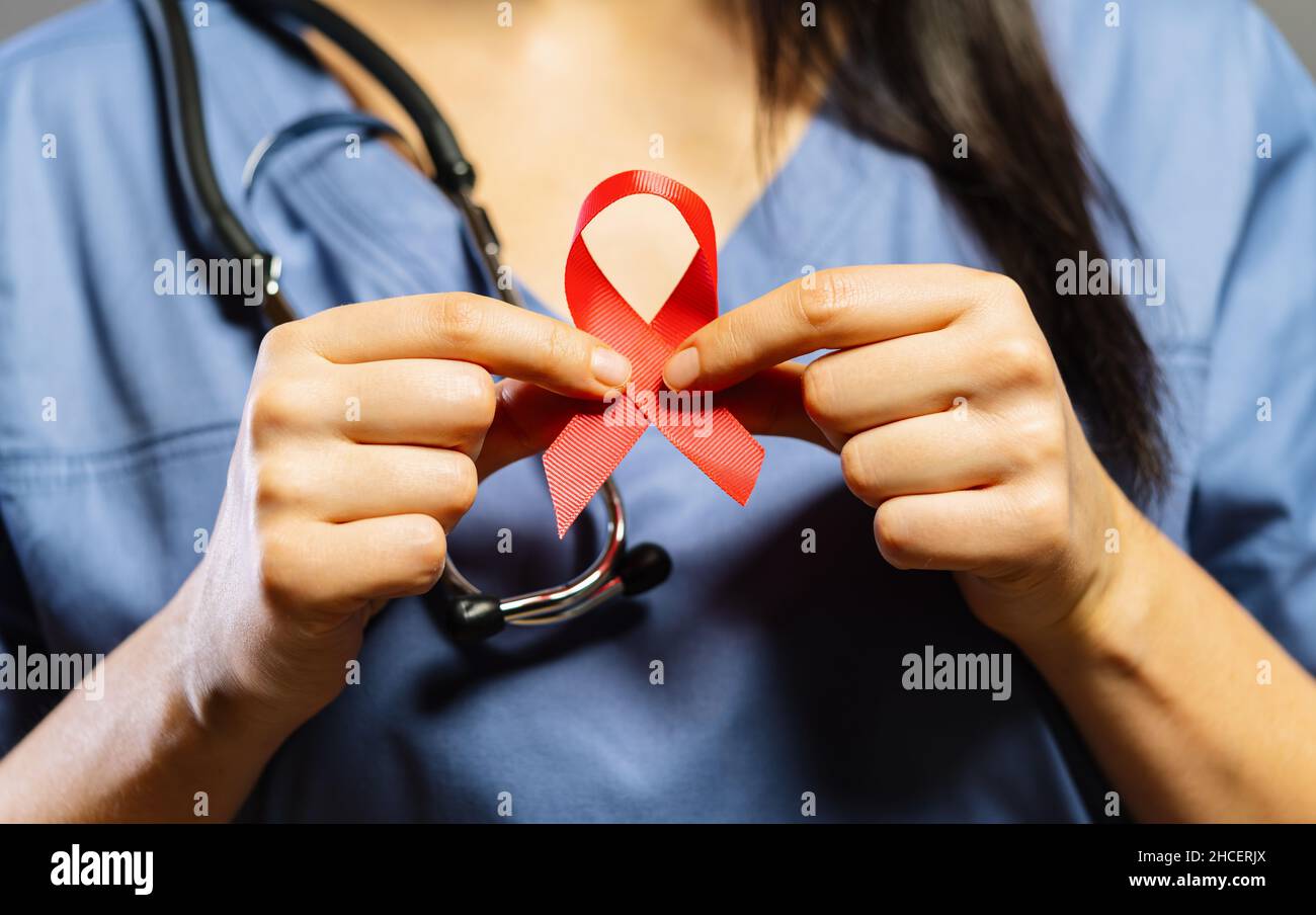 Nurse hold Red ribbon in hands for world aids day Stock Photo