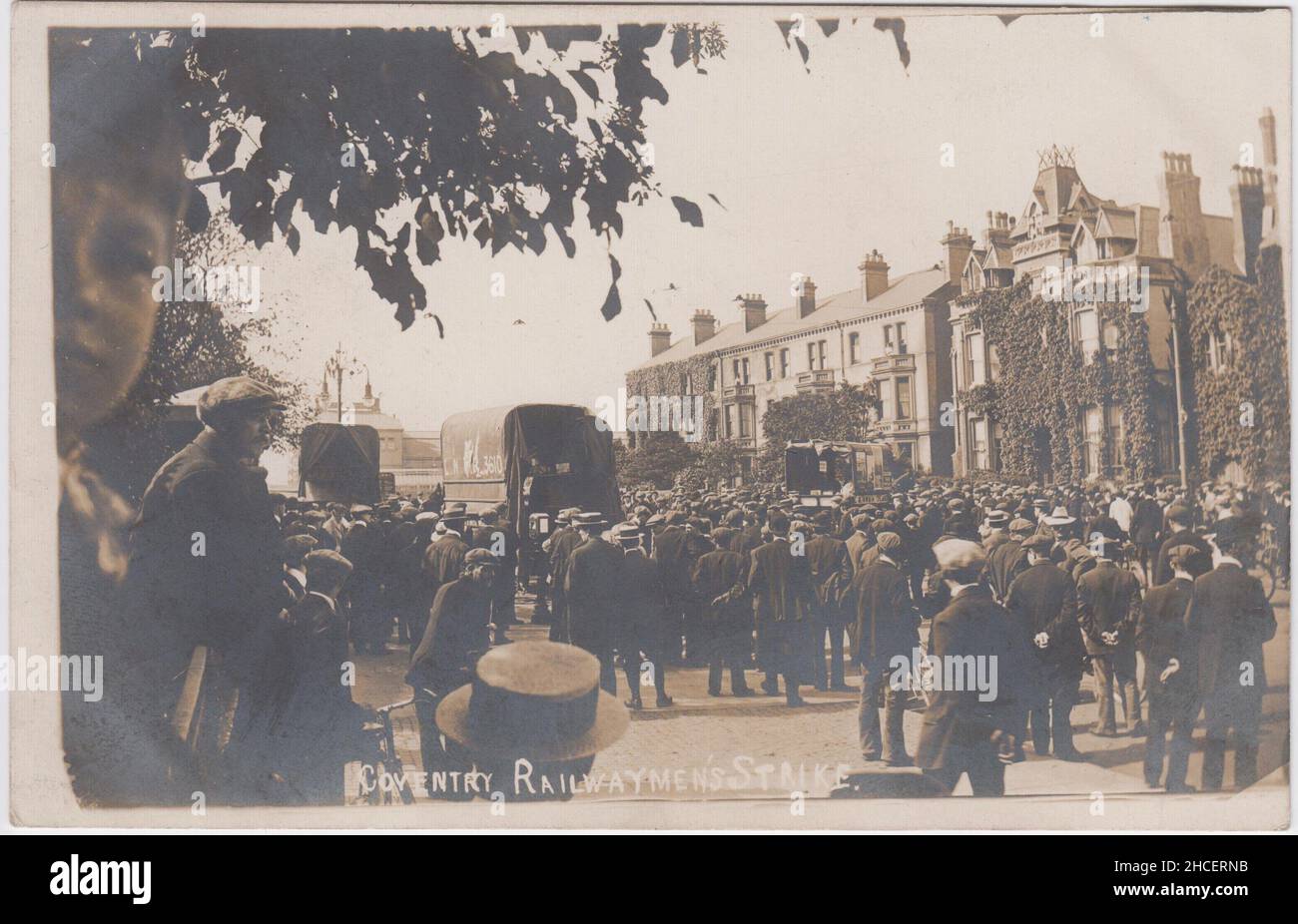 'Coventry railwaymen's strike': photograph taken during the 1911 transport workers' strike. The image shows a large group of people blocking the road to the railway station, with carts stopped in the road. A young boy is looking into the camera Stock Photo