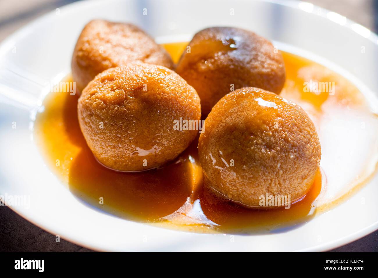 sugar filled roll, commonly known as 'Rasgulla' or ' Nolen Gurer Rosogolla' in Bengali is made of new Jaggery and Curd. Stock Photo