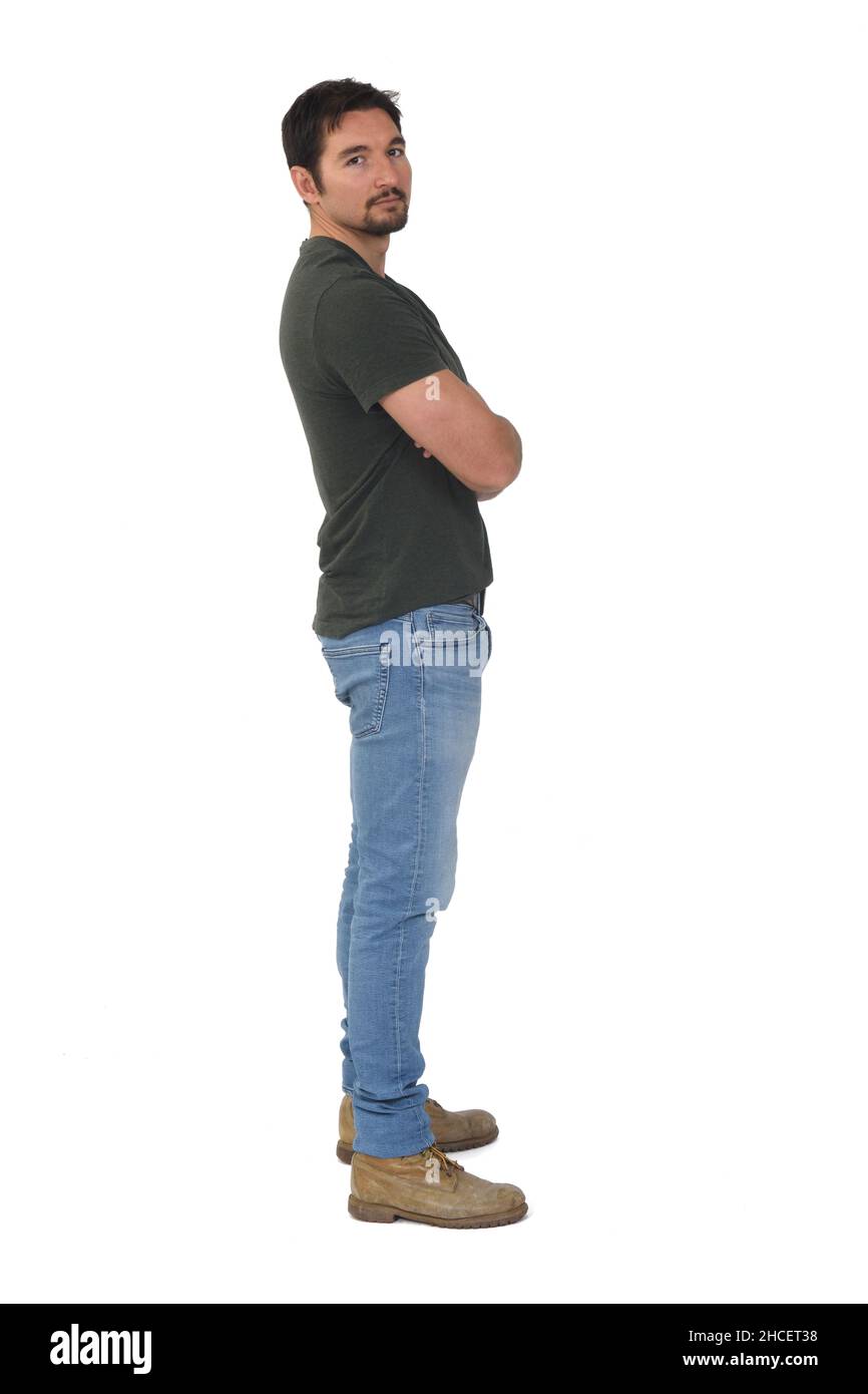 full portrait of a man in profile looking at camera and arms crossed on ...