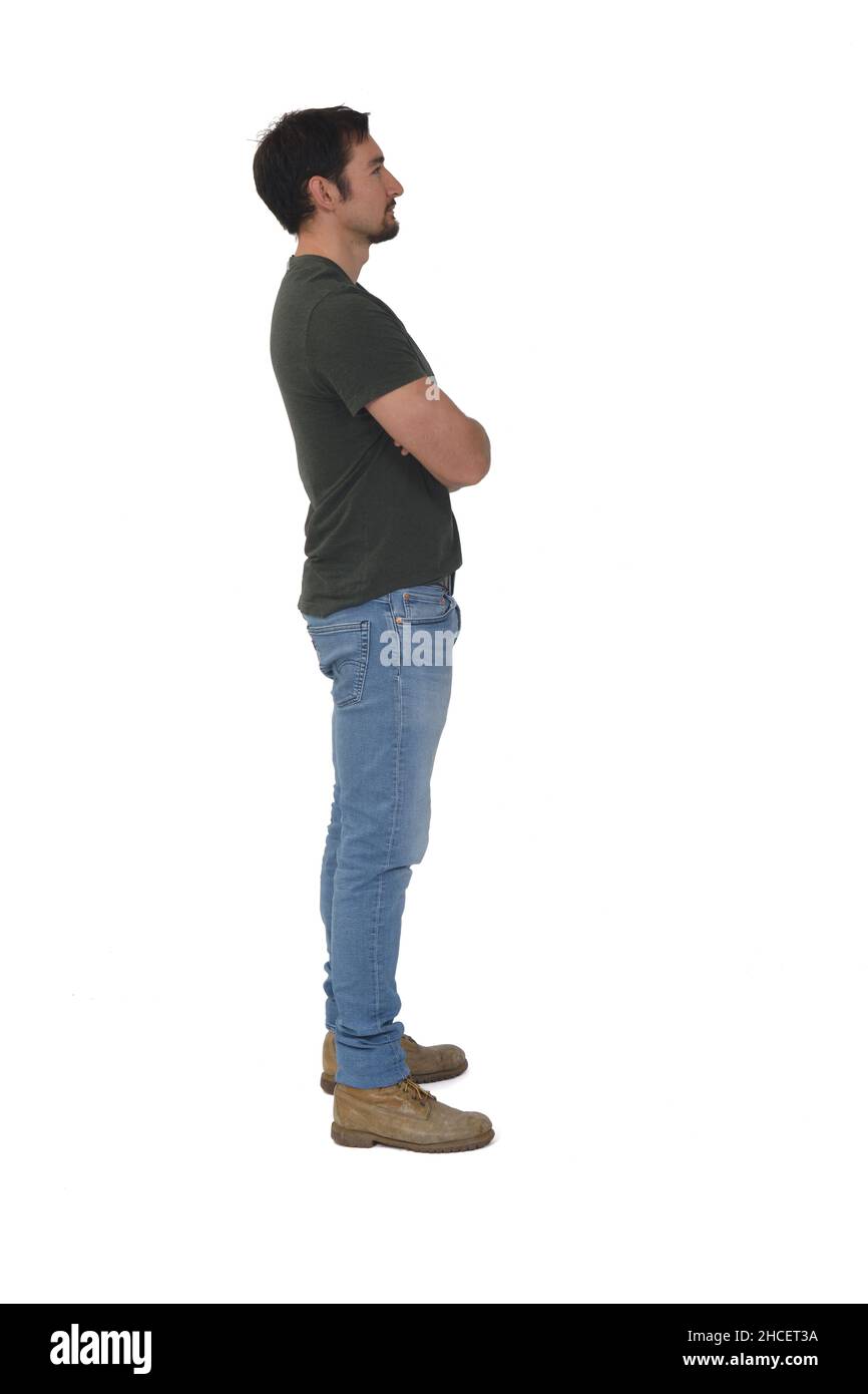 full portrait of a man in profile looking away and arms crossed on ...