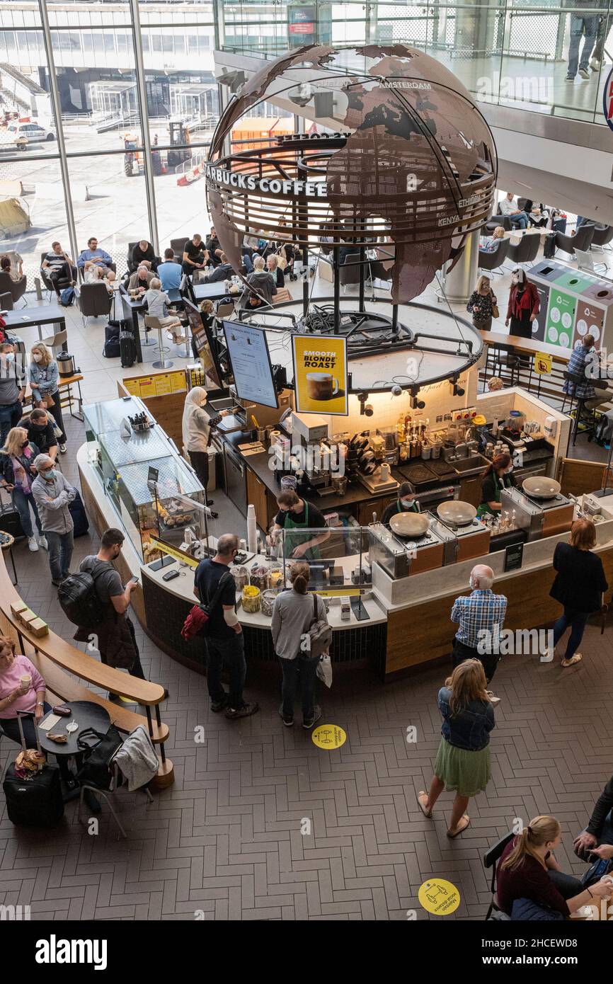 Starbucks coffe shop in the departures lounge with passengers queing to