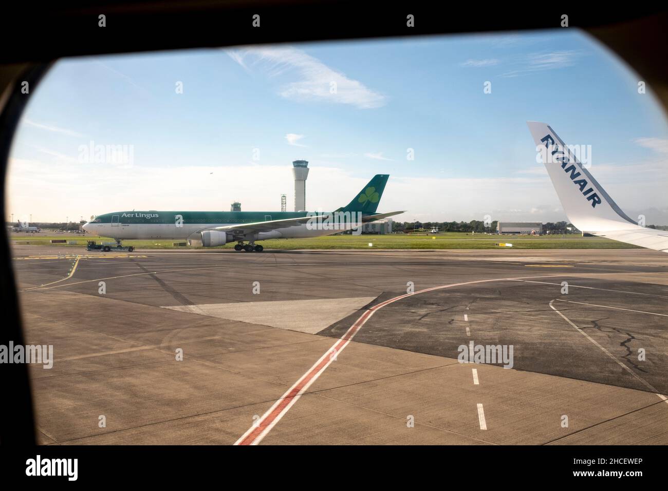 View from inside a Ryanair flight to an Aer lingus plane on the taxiway at Dublin Airport, Dublin, Ireland Stock Photo