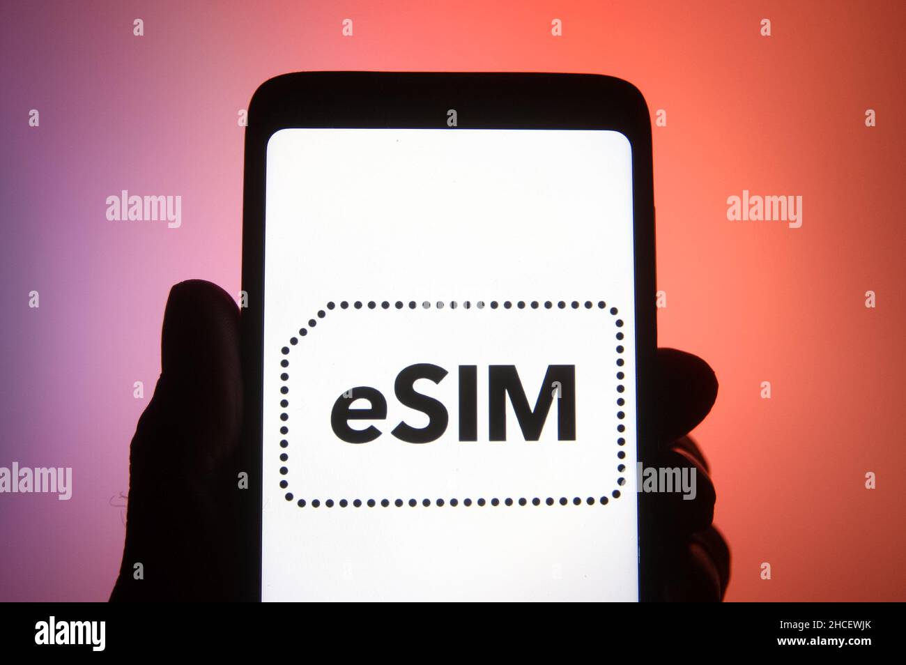 Ukraine. 27th Dec, 2021. In this photo illustration, eSIM word, name of an embedded integrated programmable SIM card that is embedded directly into a mobile phone, is seen on a smartphone. (Credit Image: © Pavlo Gonchar/SOPA Images via ZUMA Press Wire) Stock Photo