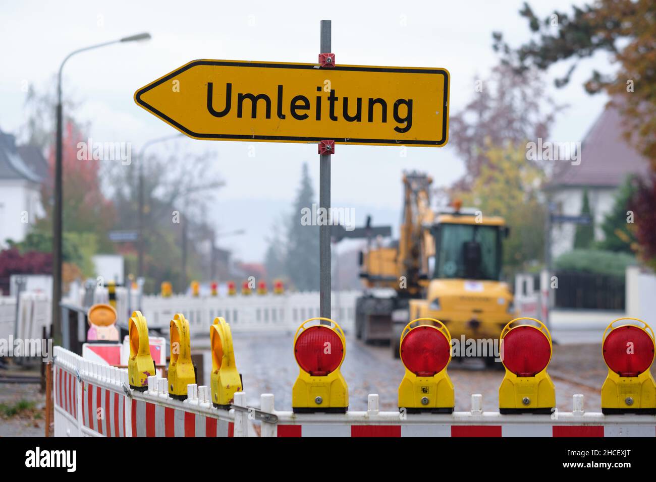 Nuremberg, Germany - November 01, 2021: A Umleitung ( detour ) traffic sign at a closed road due to a  construction site with construction vehicles Stock Photo