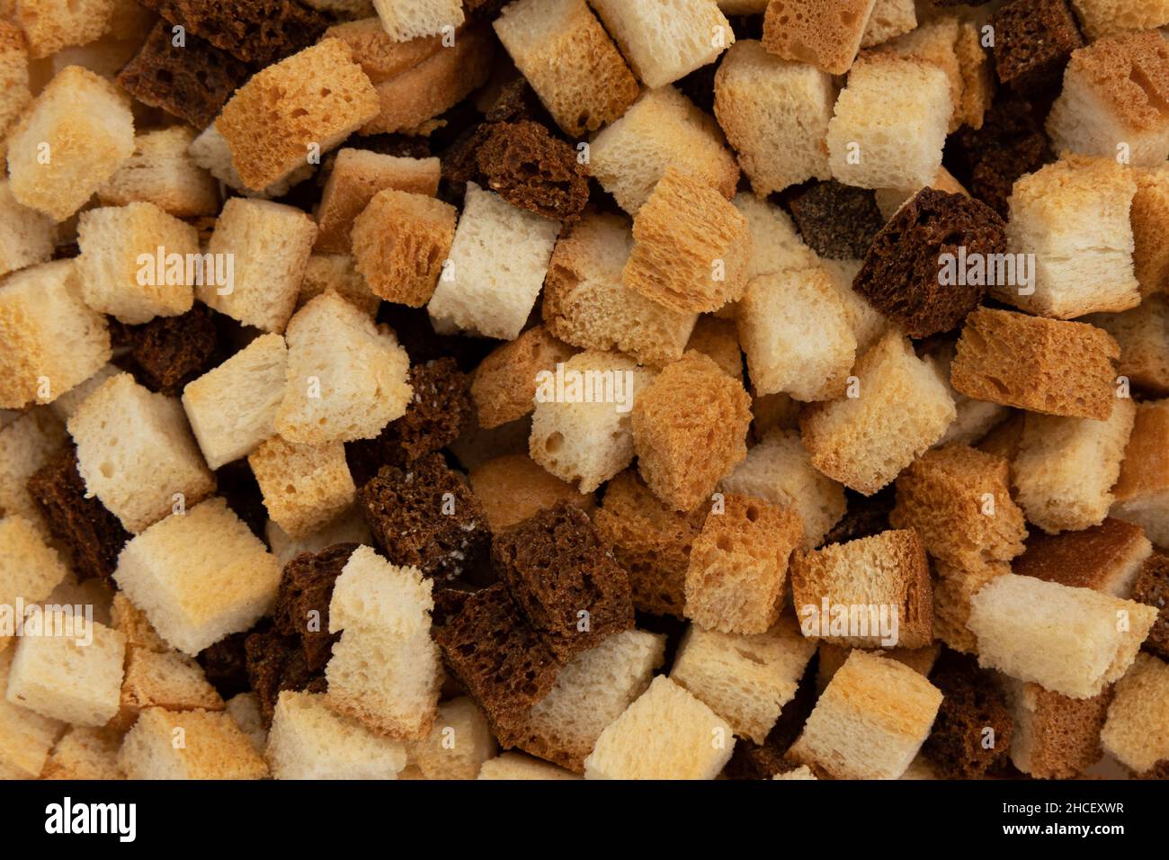 pile of homemade bread croutons, background of homemade rus, top view
