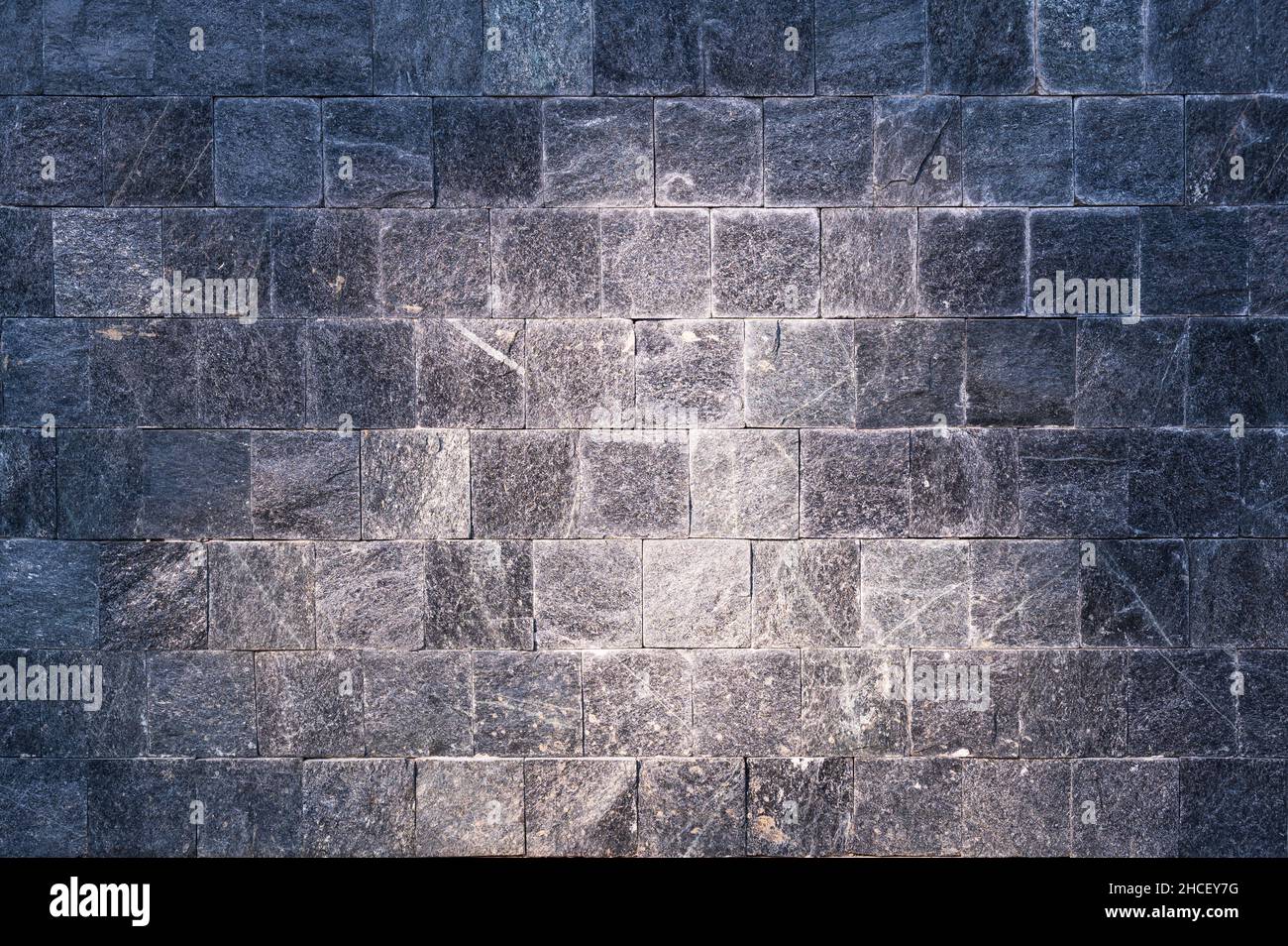 rock wall background texture rough granite stone block wall Stock Photo