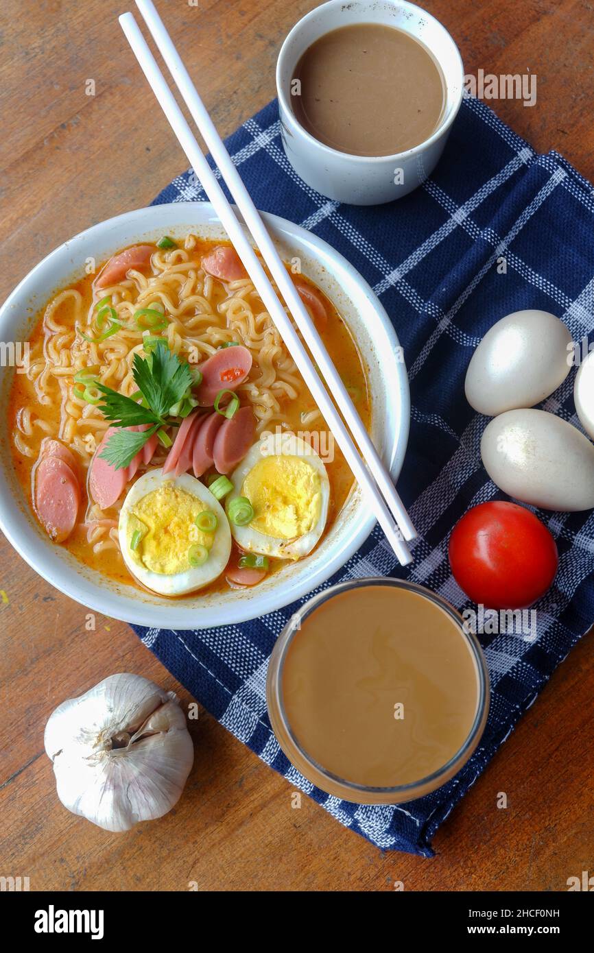 Photo of noodle soup with toppings such as sausages, eggs, and vegetables Stock Photo Alamy