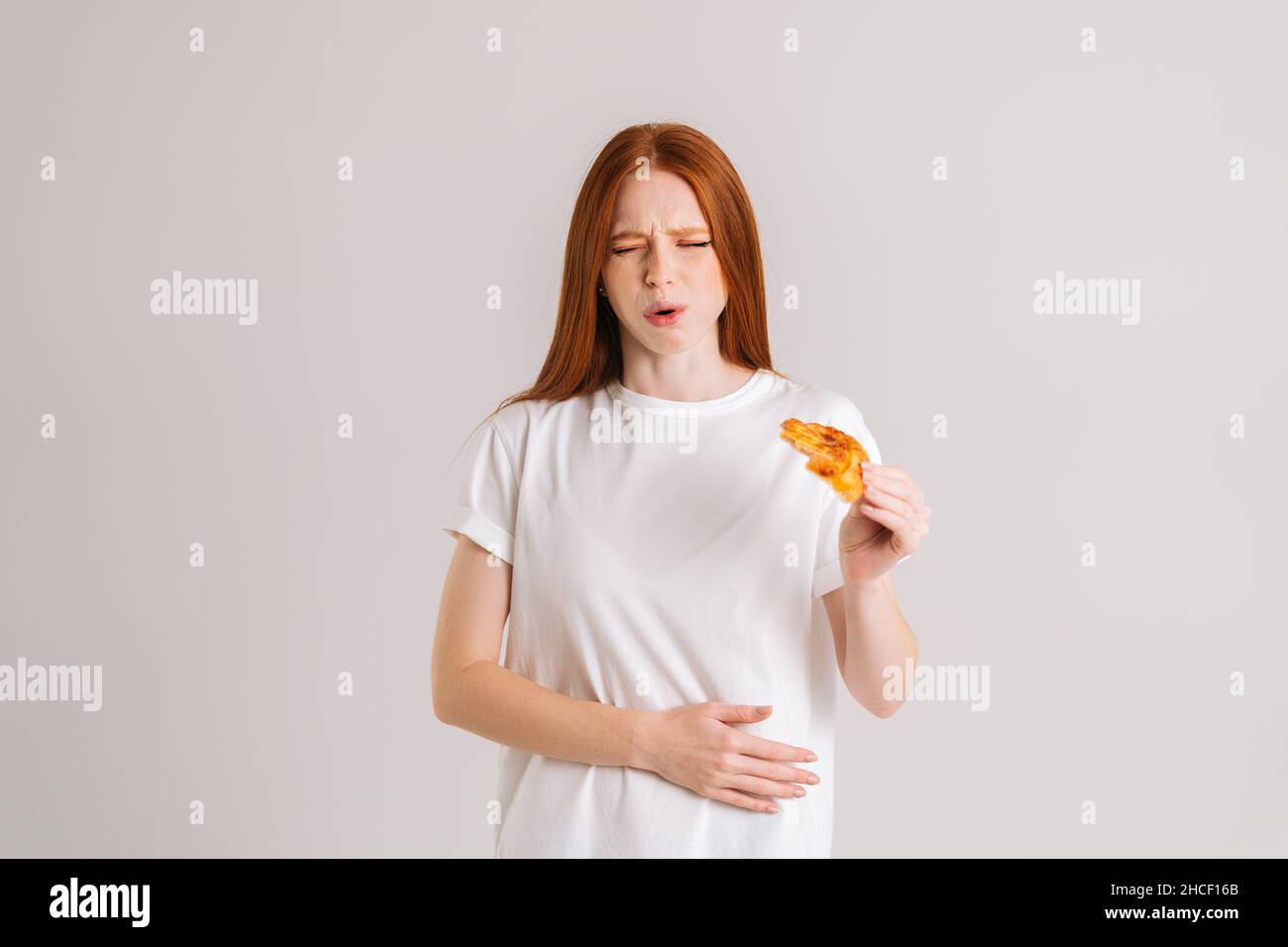 Studio portrait of attractive sick young woman closed eyes feeling pain