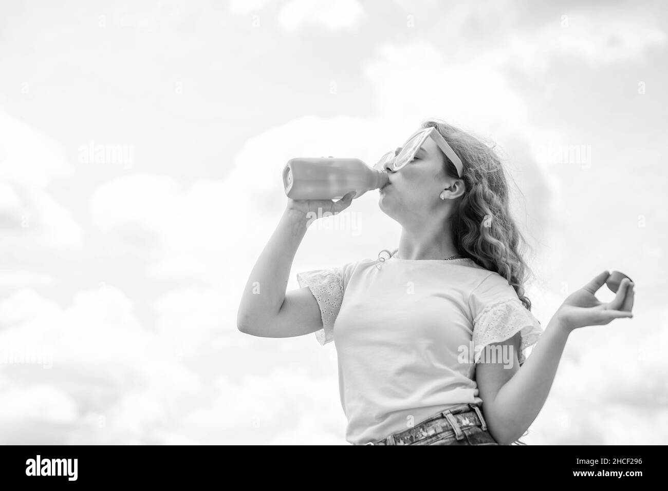 wearing funny party glasses. kid fashion style. teenage girl on sky background outdoor. hipster kid. happy childrens day. happy childhood. smiling Stock Photo