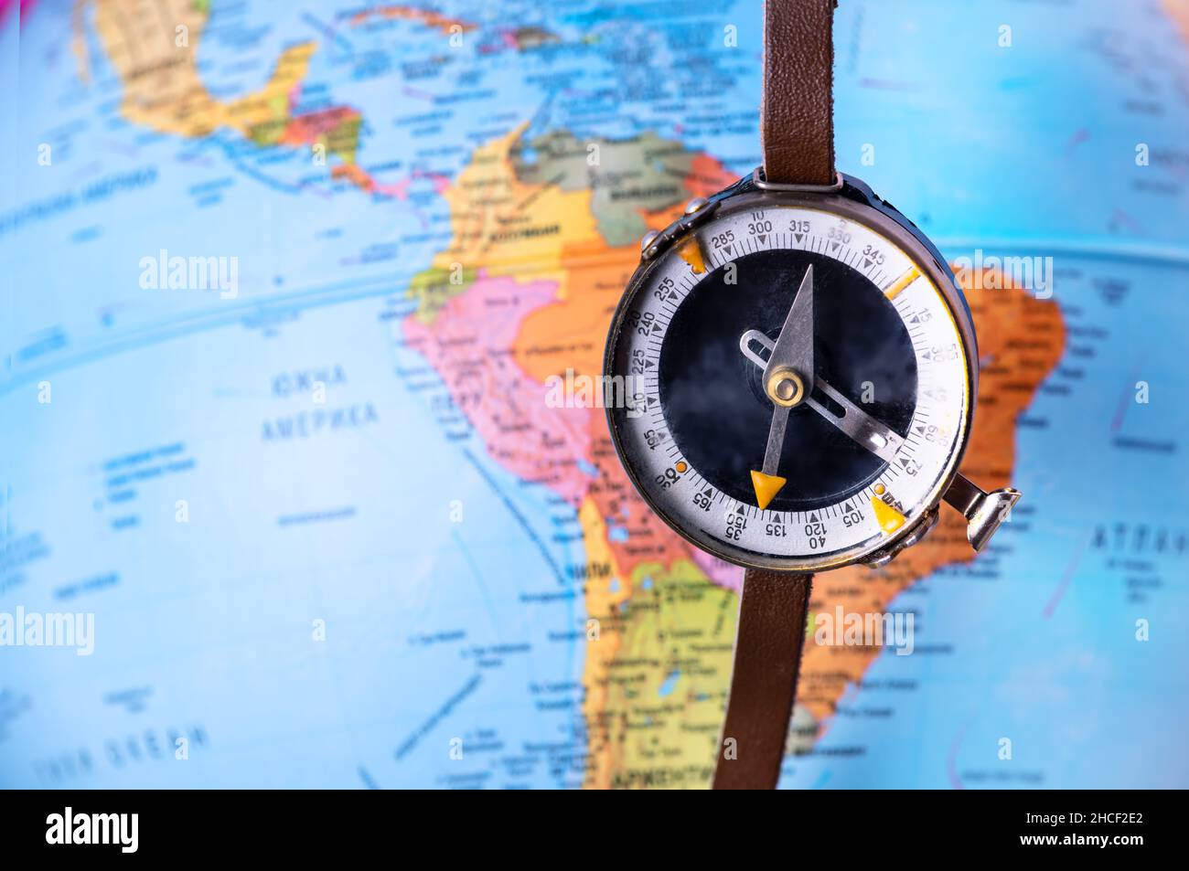 Compass on top of world map. Magnetic compass on world map. Stock Photo