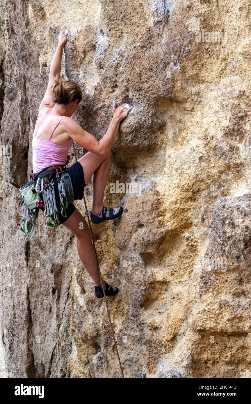 single female rock climbing at Smith Rock State Park, Oregon Stock Photo