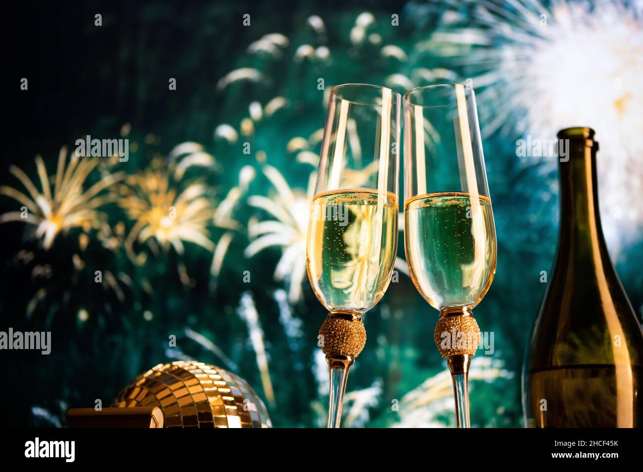 happy New Year champagne glasses and fireworks celebration background ...