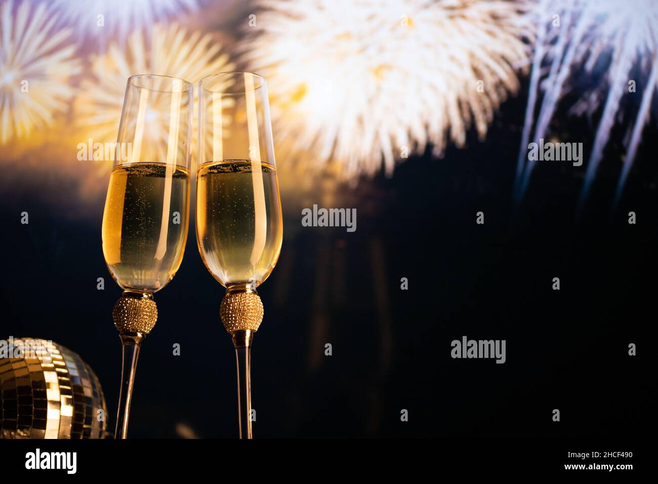 happy New Year champagne glasses and fireworks celebration background ...