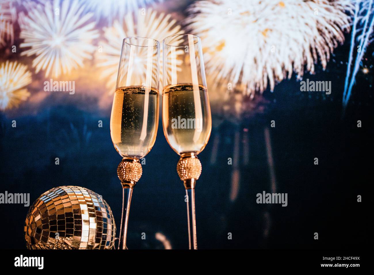 happy New Year champagne glasses and fireworks celebration background ...