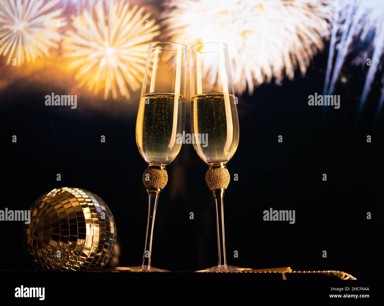 happy New Year champagne glasses and fireworks celebration background ...