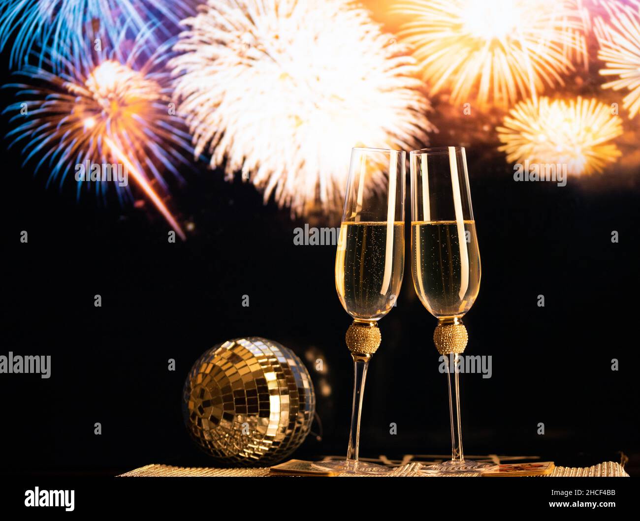 happy New Year champagne glasses and fireworks celebration background ...