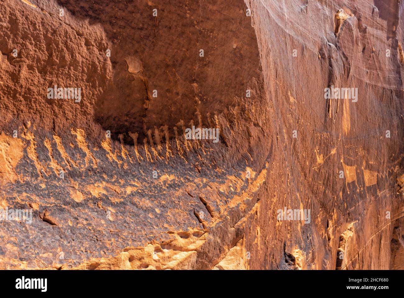 A line of figures leads into the Procession Panel, a well-known Ancetral Puebloan petroglyph panel near the top of Comb Ridge in Bears Ears National M Stock Photo