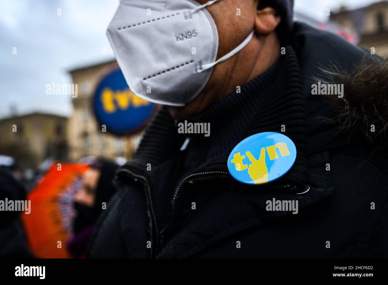 A badge with a logo of TVN broadcasting company and a 'victory' gesture is seen on a protester's coat.  Poland's parliament recently passed a controve Stock Photo