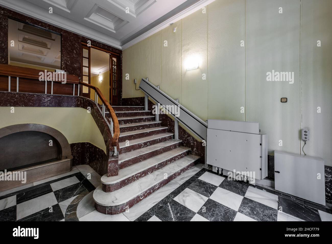 Marble stairs going up to residential homes and stair lifts for wheelchairs Stock Photo