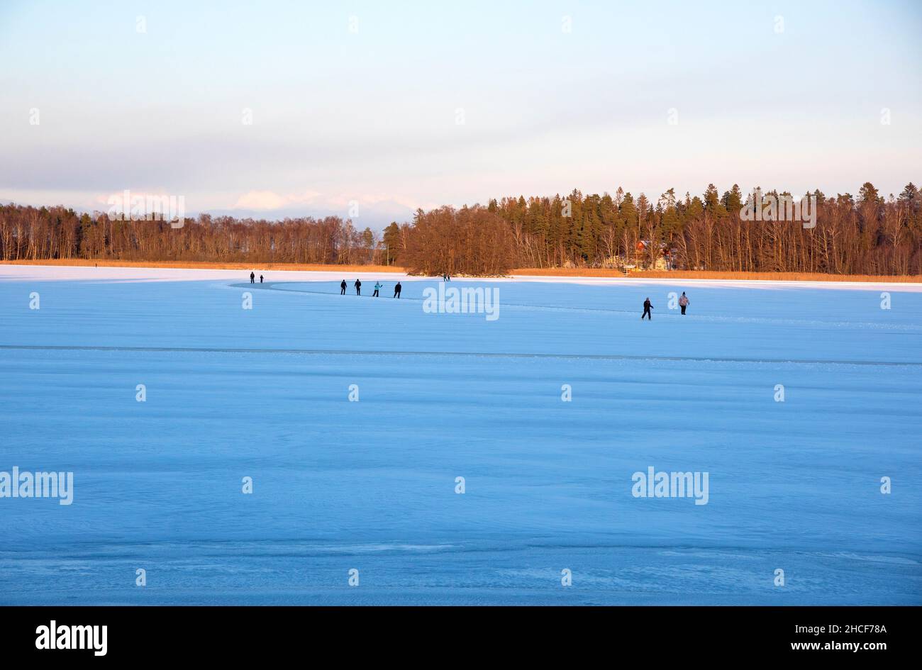 People skating on frozen lake Stock Photo - Alamy
