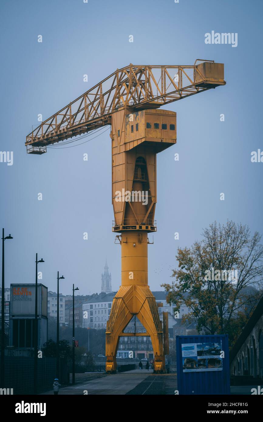 Vertical shot of a yellow titan crane symbol of Nantes city in France Stock Photo