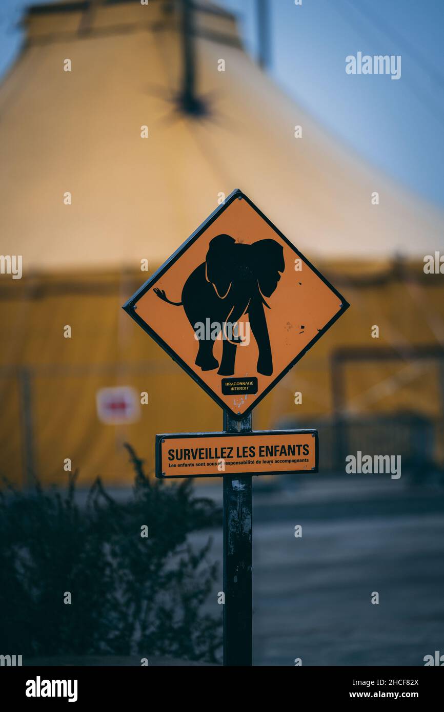 Vertical shot of a sign in French 'WATCH FOR CHILDREN' with an elephant silhouette Stock Photo