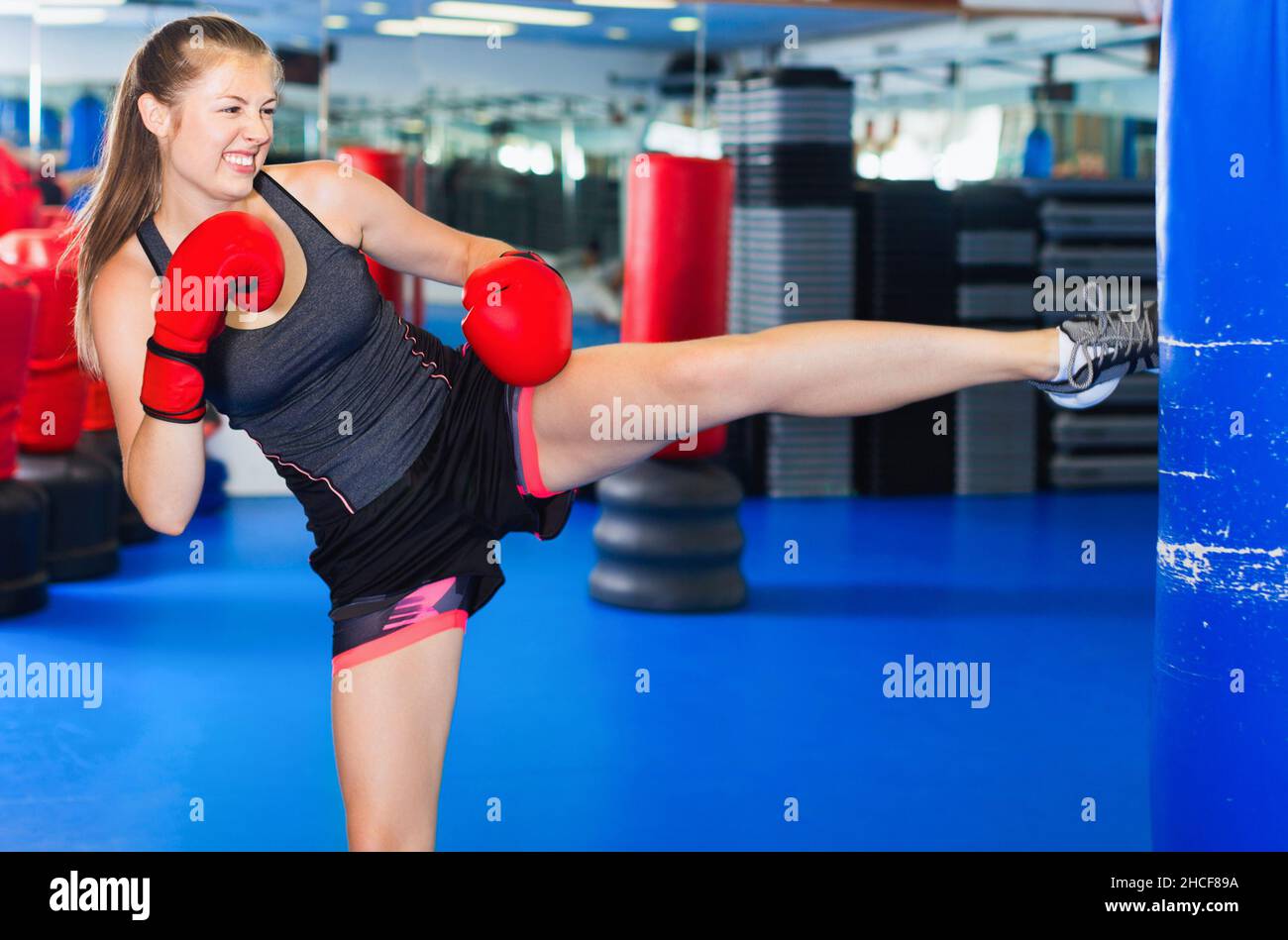 Woman boxer is training kick in box gym Stock Photo Alamy