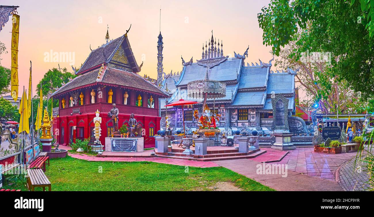 Panorama of the small garden and beautiful shrines of Silver Temple with wooden Ho Trai manuscript depository and the Ubosot behind Ganesha altar, Chi Stock Photo