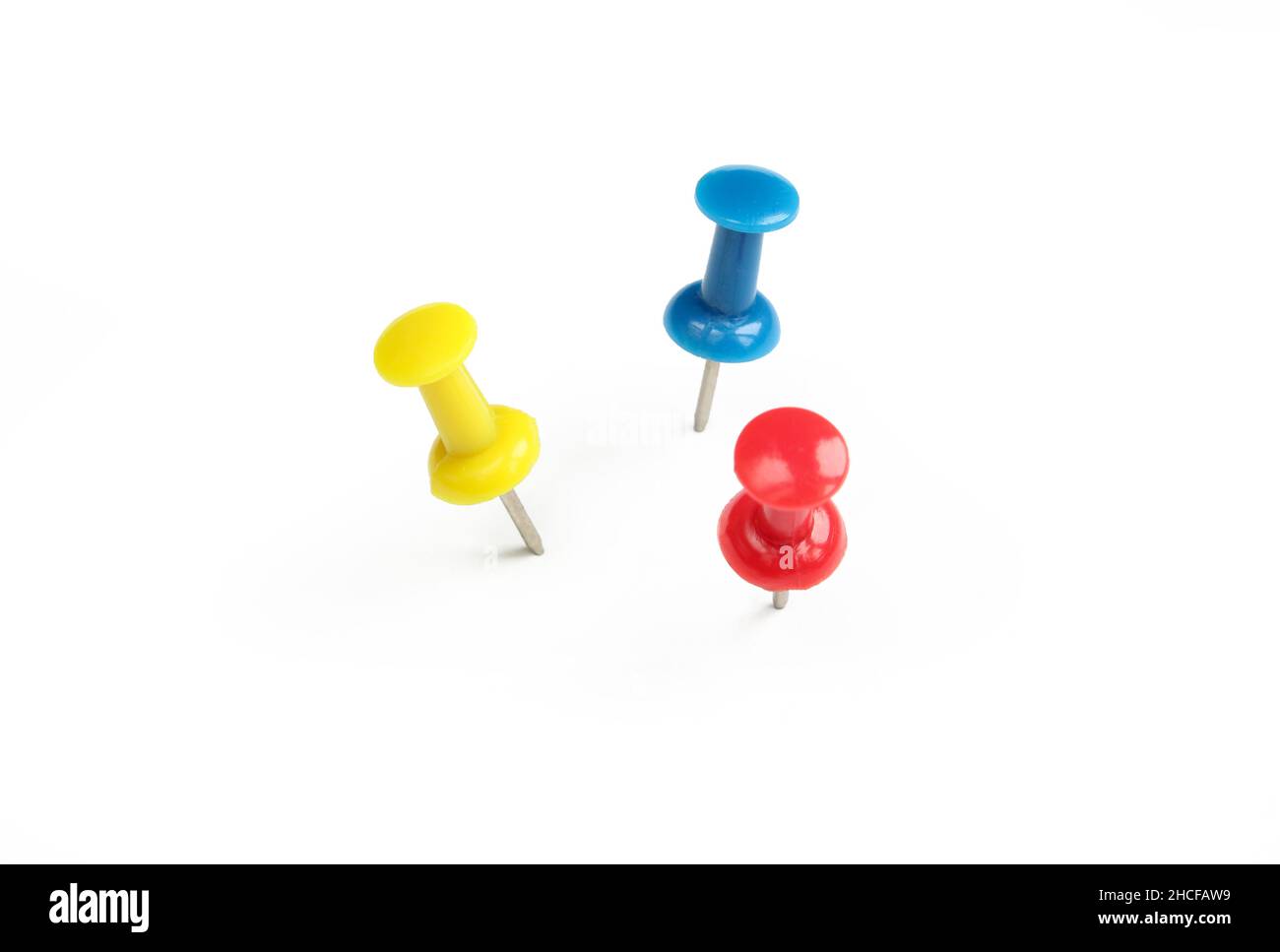 Red,yellow and blue push pin isolated on white background Stock Photo