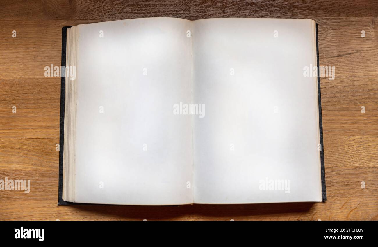 Open notebook on wooden background, top view. Blank book page on a table. Copy space, note template Stock Photo