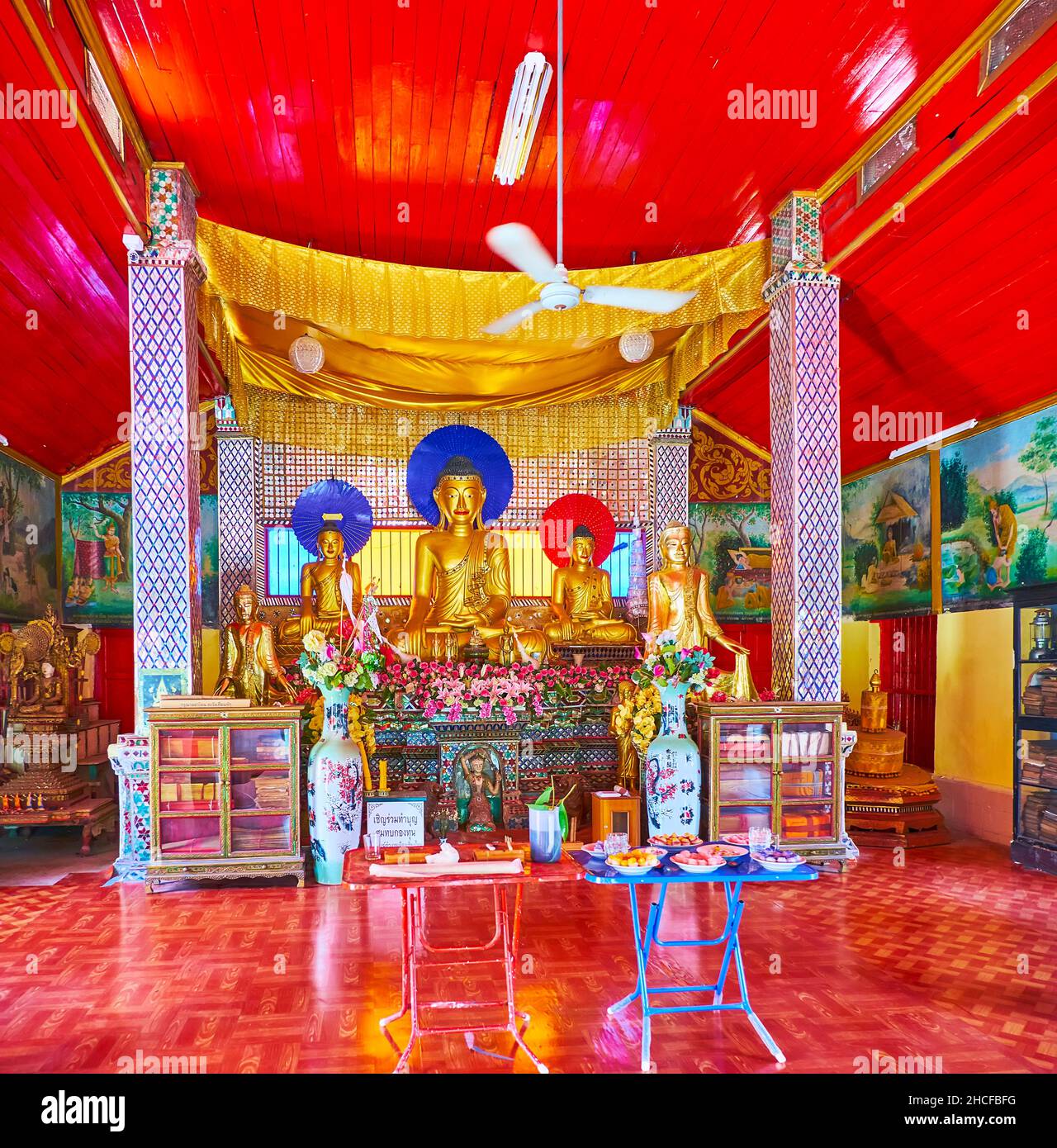CHIANG MAI, THAILAND - MAY 4, 2019: Interior of Viharn of Wat Sai Moon Myanmar temple with ornate altar, decorated with pillars and golden silk canopy Stock Photo