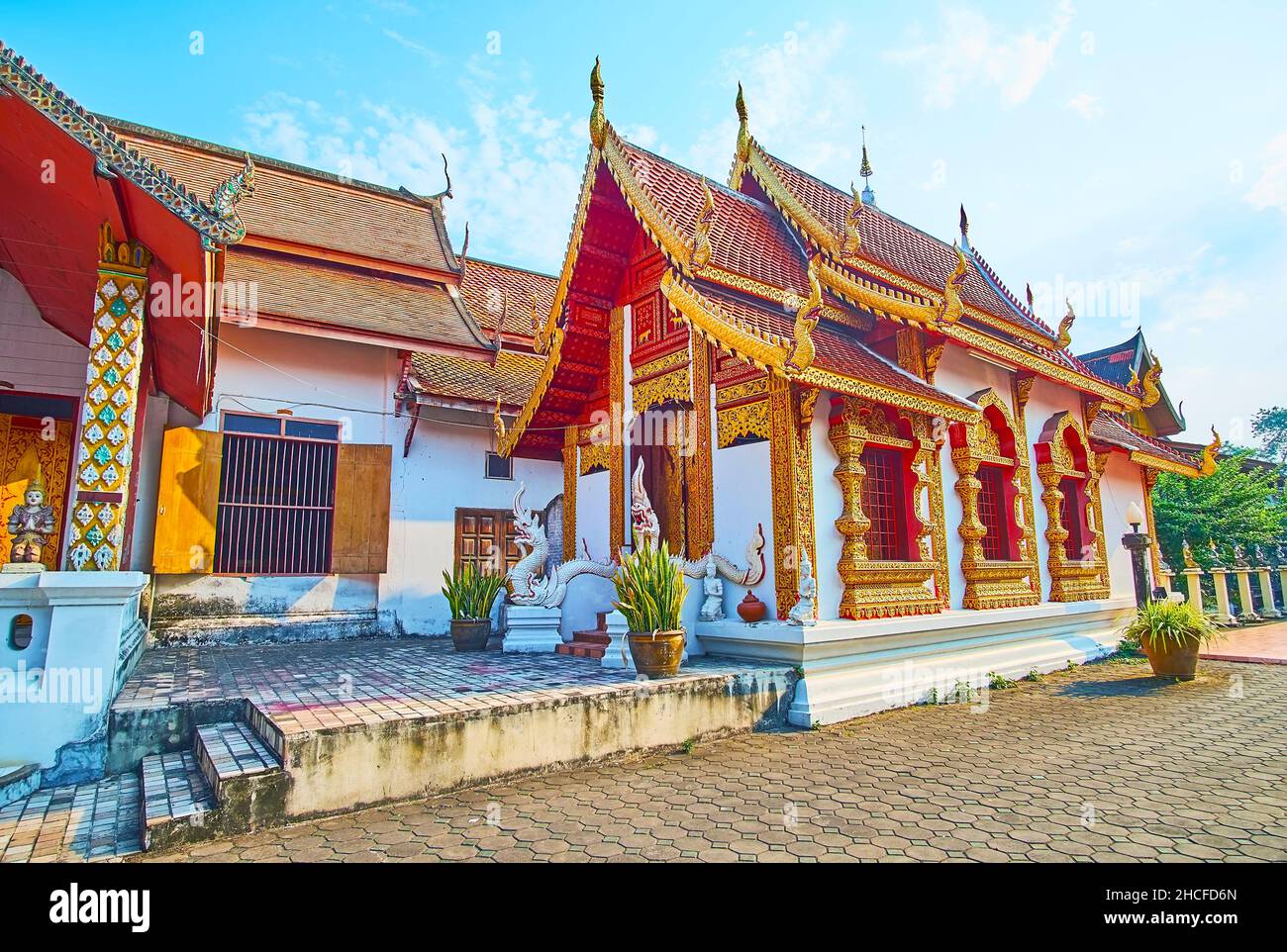 The Ubosot (Ordination Hall) of the medieval Wat Muen Ngoen Kong temple with gable (pyathat) roof, carved wooden gilt bargeboards, pillars and window Stock Photo