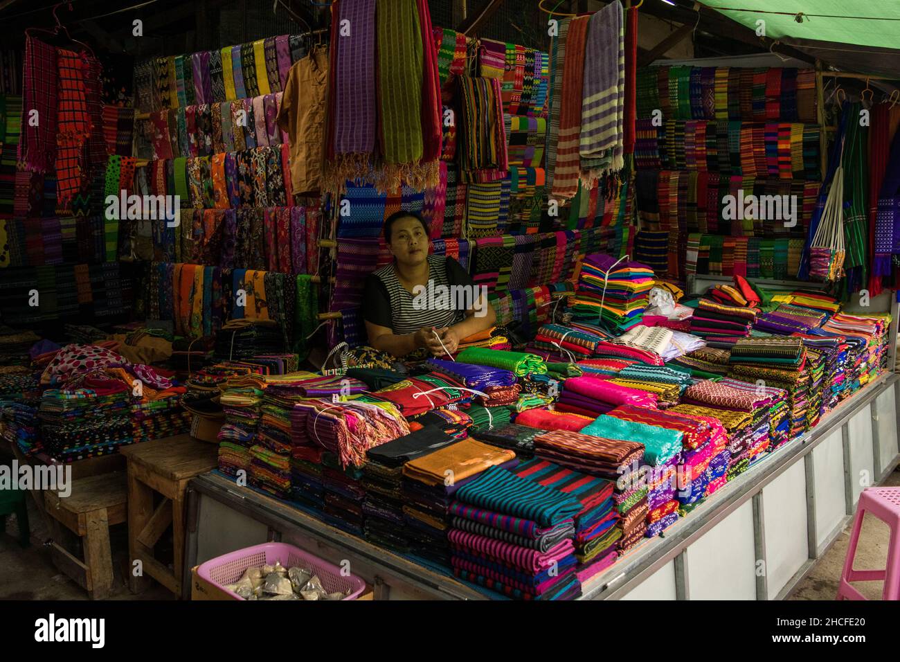 Cloth and fabric vendor, selling bright coloured products at Nyaung Shwe day market, near Inle Lake Stock Photo