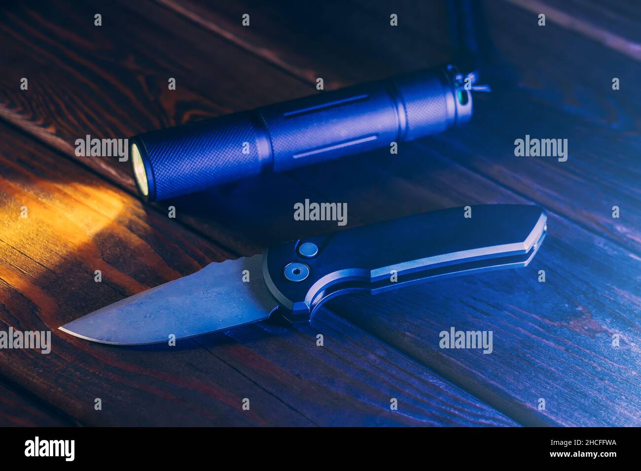 Pocket Knife and Flashlight for EDC Everyday Carry on wooden table