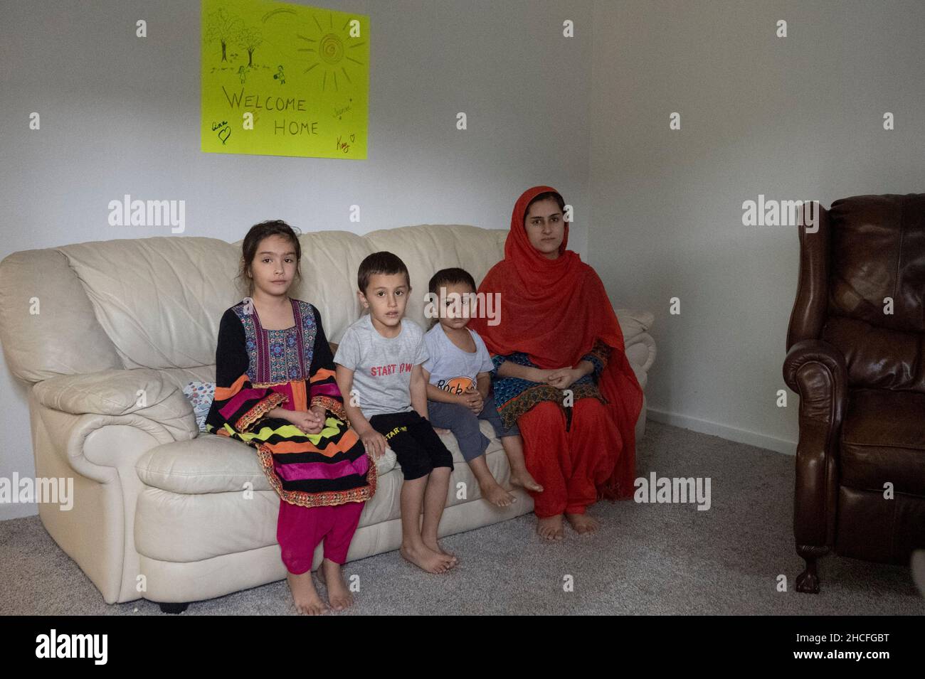 Austin, TX, USA. 19th Dec, 2021. An Afghan family poses in their new Austin apartment. For three months, refugees fleeing turmoil in Afghanistan continue to be resettled in Texas with many single men, large families with children scatttered amongst dozens of apartments in Austin, Texas. Faith-based groups have stepped up to coordinate efforts in furnishing homes for hundreds of refugees. (Credit Image: © Bob Daemmrich/ZUMA Press Wire) Stock Photo