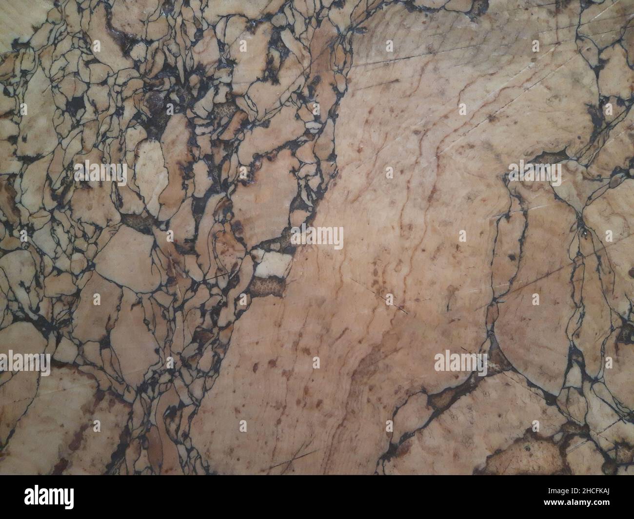 Old brown marble surface with spots on the whole frame, closeup Stock
