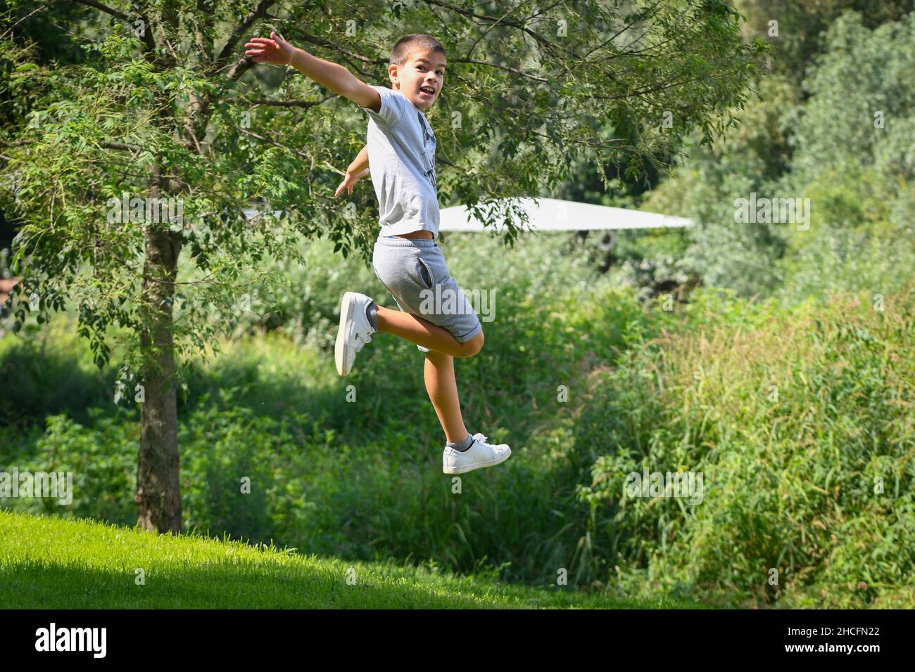 Child jumping with joy hi-res stock photography and images - Alamy